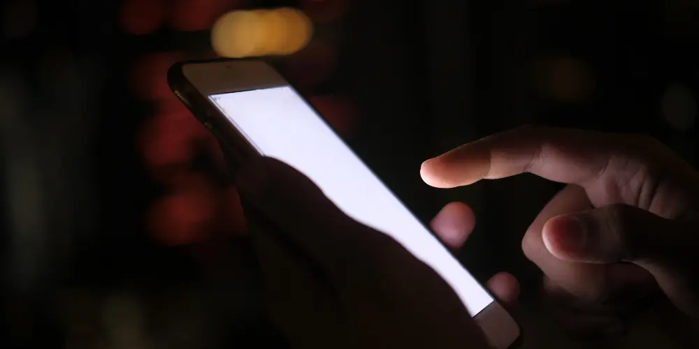 player tapping smartphone screen during fast mobile gameplay