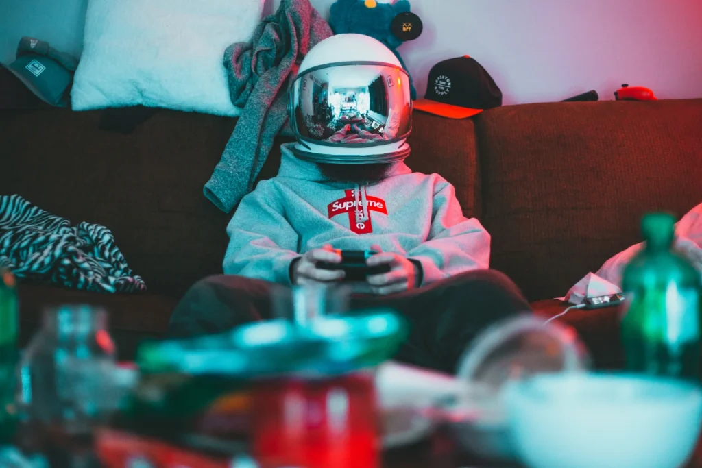 Person wearing a helmet holding a joystick, ready to play.